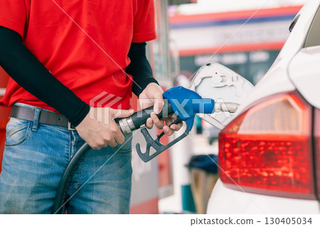 Closeup gas station staff worker hand holding fuel nozzle for refill car fuel, Petroleum business 130405034
