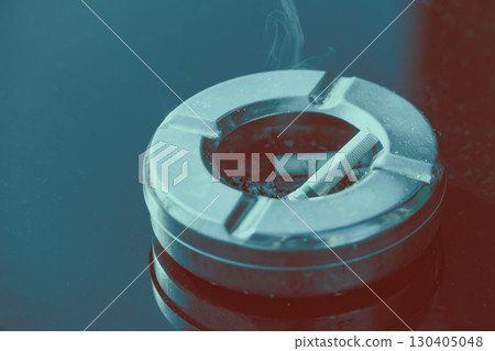 Closeup finished Cigarette butts in ashtray on black empty copy space table top with color effect Closeup finished Cigarette butts in ashtray on black empty copy space table top with color effect 130405048