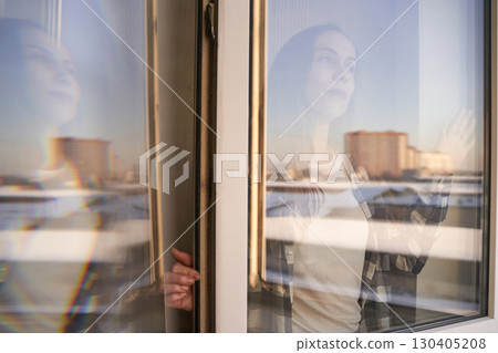 Young caucasian female gaze through window reflection in urban setting, soft Young caucasian female gaze through window reflection in urban setting, soft 130405208