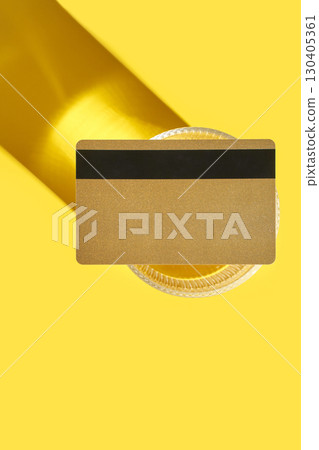 Golden credit card on vibrant yellow background with dramatic shadow and glass Golden credit card on vibrant yellow background with dramatic shadow and glass 130405361