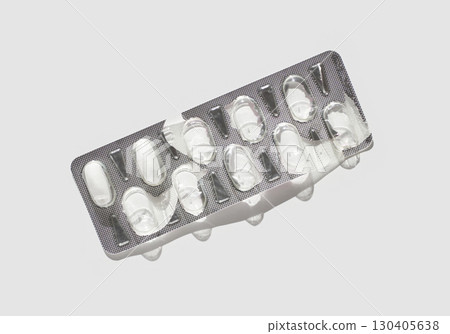Empty blister pack with silver foil on white background highlighting medication 130405638