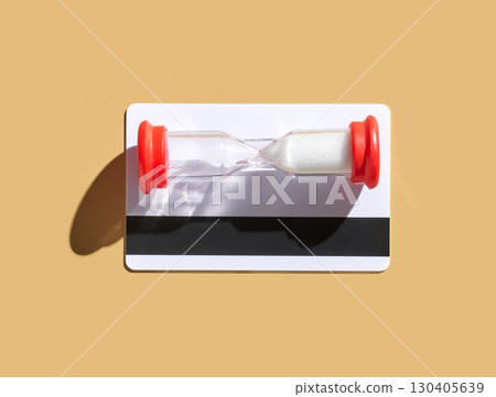 Hourglass timer on cardboard background symbolizing time passing and deadline 130405639
