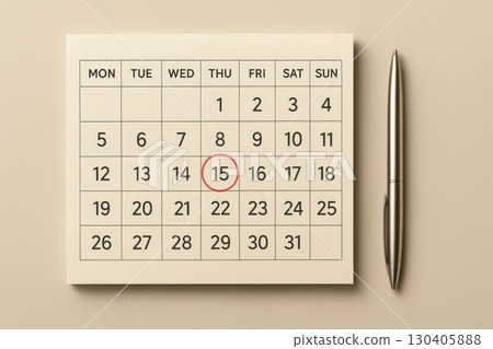 Close-up of calendar with marked date and pen on beige background for planning and scheduling. 130405888