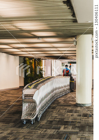 Airport staff pulling a ramp up with a vehicle baggage car. Airport staff pulling a ramp up with a vehicle baggage car. 130406111