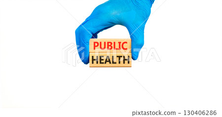 Public health symbol. Concept words Public health on beautiful wooden blocks. Doctor's hand in blue medical glove. Beautiful white background. Medical healthy lifestyle public health concept. Public health symbol. Concept words Public health on beautiful wooden blocks. Doctor's hand in blue medical glove. Beautiful white background. Medical healthy lifestyle public health concept. 130406286