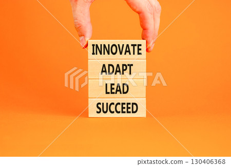 Innovate adapt lead succeed symbol. Concept words Innovate Adapt Lead Succeed on beautiful wooden blocks. Beautiful orange background. Business innovate adapt lead succeed concept. Copy space. Innovate adapt lead succeed symbol. Concept words Innovate Adapt Lead Succeed on beautiful wooden blocks. Beautiful orange background. Business innovate adapt lead succeed concept. Copy space. 130406368