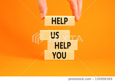 Help you symbol. Concept words phrase Help us help you on beautiful wooden blocks. Beautiful orange paper background. Businessman's hand. Business Help you concept. Copy space. 130406369