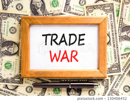 Trade war symbol. Concept word Trade war on beautiful wooden picture frame. Dollar bills. Beautiful dollar bills background. Black pen. Business trade war concept. Copy space. Trade war symbol. Concept word Trade war on beautiful wooden picture frame. Dollar bills. Beautiful dollar bills background. Black pen. Business trade war concept. Copy space. 130406452