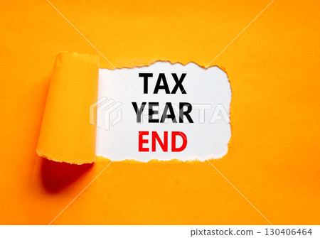 Tax year end symbol. Concept words Tax year end on beautiful white paper. Beautiful orange table orange background. Business tax year end concept. Copy space. 130406464