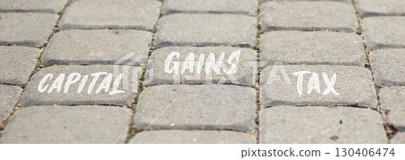 Capital gains tax symbol. Concept words Capital gains tax on beautiful grey road break. Beautiful grey road break background. Business and capital gains tax concept. Copy space. 130406474