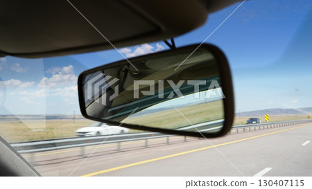Rear view mirror reflecting car passing on highway road Rear view mirror reflecting car passing on highway road 130407115