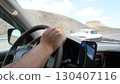 Driver using gps navigation on smartphone while driving car on mountain road 130407116
