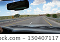 Driving on a scenic highway under a cloudy sky 130407117