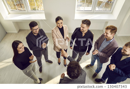 Team of happy people showing their recognition to successful young business woman 130407343