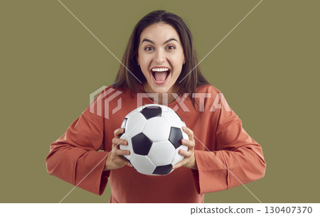 Portrait of funny soccer fan woman who is happy with crazy and happy expression on her face. 130407370