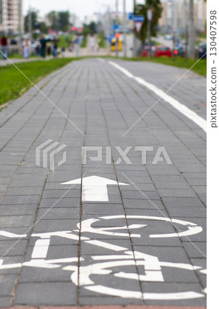 Bicycle Path Featuring Directional Arrow Located in Urban Environment Bicycle Path Featuring Directional Arrow Located in Urban Environment 130407598