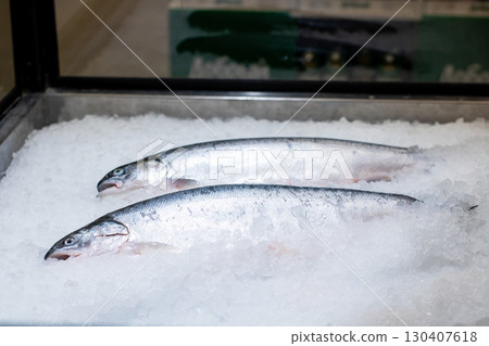 A Beautiful Display of Fresh Salmon on Ice in a Seafood Market 130407618