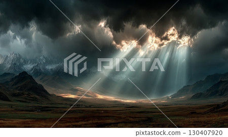 Sunlight breaking through dark storm clouds over mountain landscape 130407920