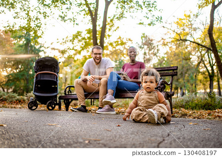 Family enjoying a sunny day in the park with laughter and joy 130408197