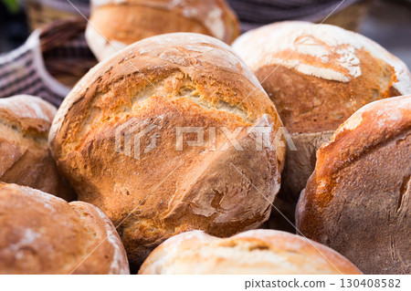 ruddy rolls of fresh warm grain bread 130408582