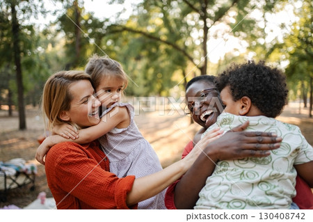 Mothers embracing their children in a park 130408742