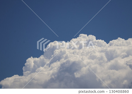 A skyscape of white, fluffy cumulonimbus clouds rising from the blue sky A skyscape of white, fluffy cumulonimbus clouds rising from the blue sky 130408860