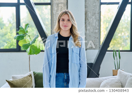 Portrait of young beautiful smiling woman in home interior Portrait of young beautiful smiling woman in home interior 130408943