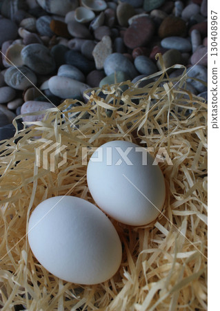 Vertical Stock Photo Of Two Whole Eggs In A Nest On A Sea Stones  130408967