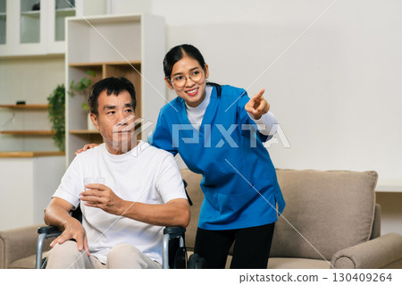 physiotherapist taking care of the happy senior patient in a medical clinic. 130409264