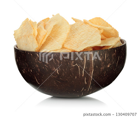 Coconut shell bowl filled with potato chips isolated on transparent background. Eco friendly natural tableware for snack food, sustainable zero waste lifestyle. Full focus photo Coconut shell bowl filled with potato chips isolated on transparent background. Eco friendly natural tableware for snack food, sustainable zero waste lifestyle. Full focus photo 130409707