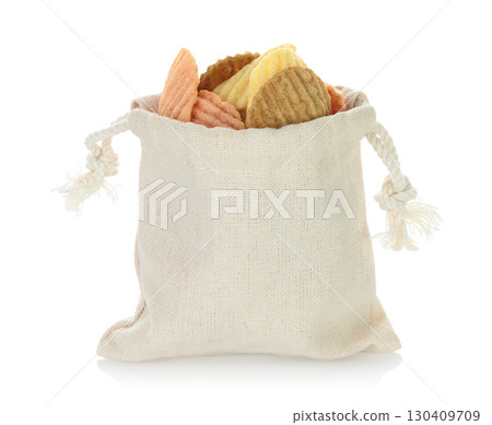 Open cotton fabric bag filled with assorted vegetable chips isolated on transparent background. Eco friendly zero waste packaging for healthy vegan and organic snack food. Full focus photo 130409709