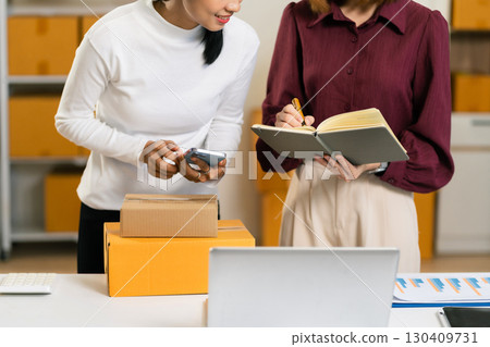 Concept of selling products online.entrepreneur or freelance checking orders from customers, woman runs an e-commerce business on websites and social media. 130409731
