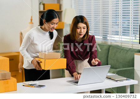 Concept of selling products online.entrepreneur or freelance checking orders from customers, woman runs an e-commerce business on websites and social media. Concept of selling products online.entrepreneur or freelance checking orders from customers, woman runs an e-commerce business on websites and social media. 130409732