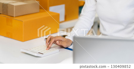 Entrepreneur working at home. Online shopping, e-commerce, internet banking, spending money, working from home concept. Entrepreneur working at home. Online shopping, e-commerce, internet banking, spending money, working from home concept. 130409852