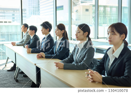 People in suits standing side by side People in suits standing side by side 130410078