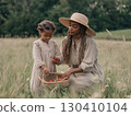 A young African American mother and daughter gently place strawberries 130410104