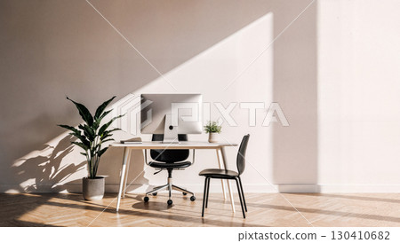 Cozy Home Office with Laptop, Notepad, and Plant in Sunlit Room 130410682