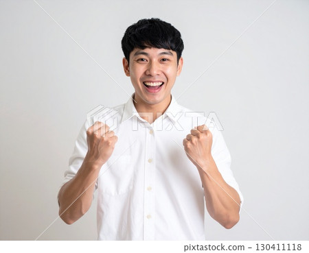 A young man celebrating with a fist pump A young man celebrating with a fist pump 130411118
