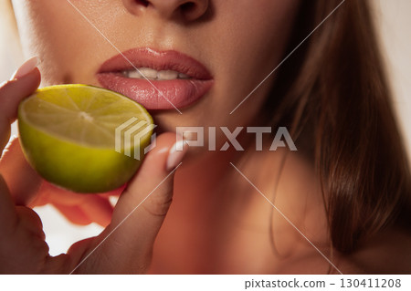 Close up lips with lime slice minimal wellness beauty Close up lips with lime slice minimal wellness beauty 130411208