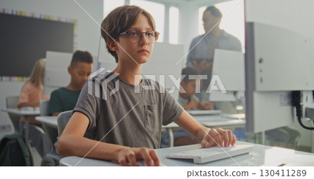Smart Young Boy Using Computer, Learning Coding During Digital Programming Lesson 130411289
