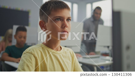 Young Boy Working on Creative Project on Computer, Practicing Digital Skills and Studying Programming 130411306