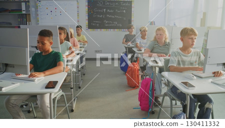 Primary School Students Working on Creative Projects on Computers 130411332