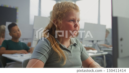 Young Girl Working on Creative Project on Computer, Practicing Digital Skills and Studying Programming 130411414