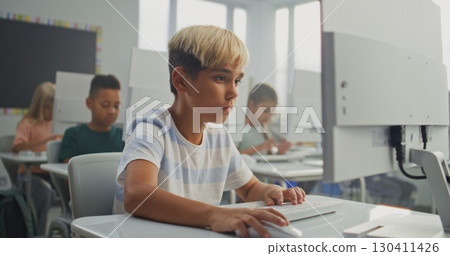 Young Boy Working on Creative Project on Computer, Practicing Digital Skills and Studying Programming 130411426