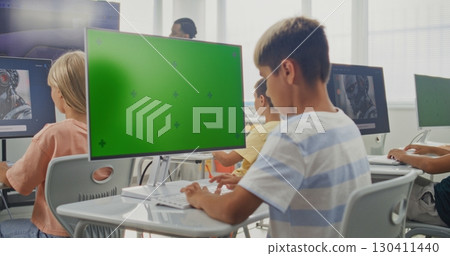 Elementary School Boy Using Computer with Green Screen Mockup During Digital Art Lesson Elementary School Boy Using Computer with Green Screen Mockup During Digital Art Lesson 130411440