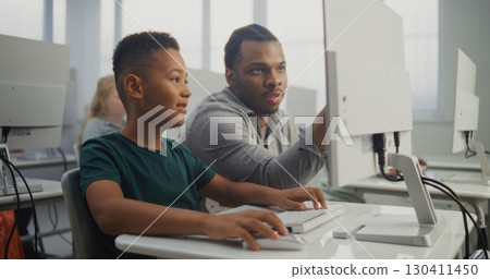 Smart Boy Using Computer, Doing 3D Design Project. Teacher Helping Young Elementary School Student Smart Boy Using Computer, Doing 3D Design Project. Teacher Helping Young Elementary School Student 130411450