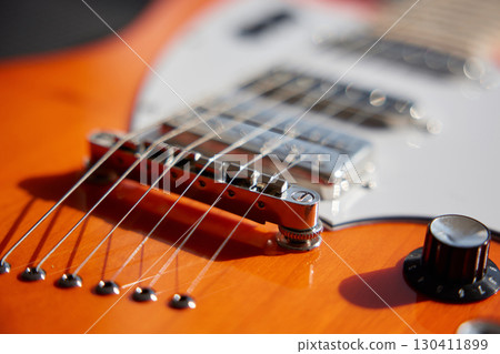 Guitar with a volume knob for sound adjustments close-up 130411899