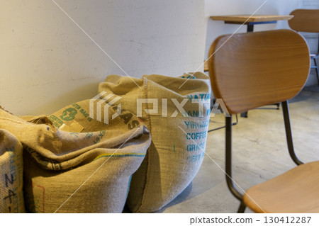 A corner of the cafe lined with burlap bags of coffee beans A corner of the cafe lined with burlap bags of coffee beans 130412287