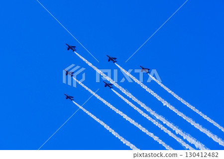 Fighter formation flying in a cloudless blue sky and smoke trails Fighter formation flying in a cloudless blue sky and smoke trails 130412482