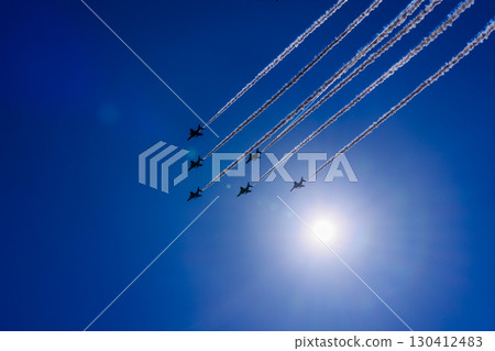 Fighter formation flight and contrails soaring through the blue sky Fighter formation flight and contrails soaring through the blue sky 130412483